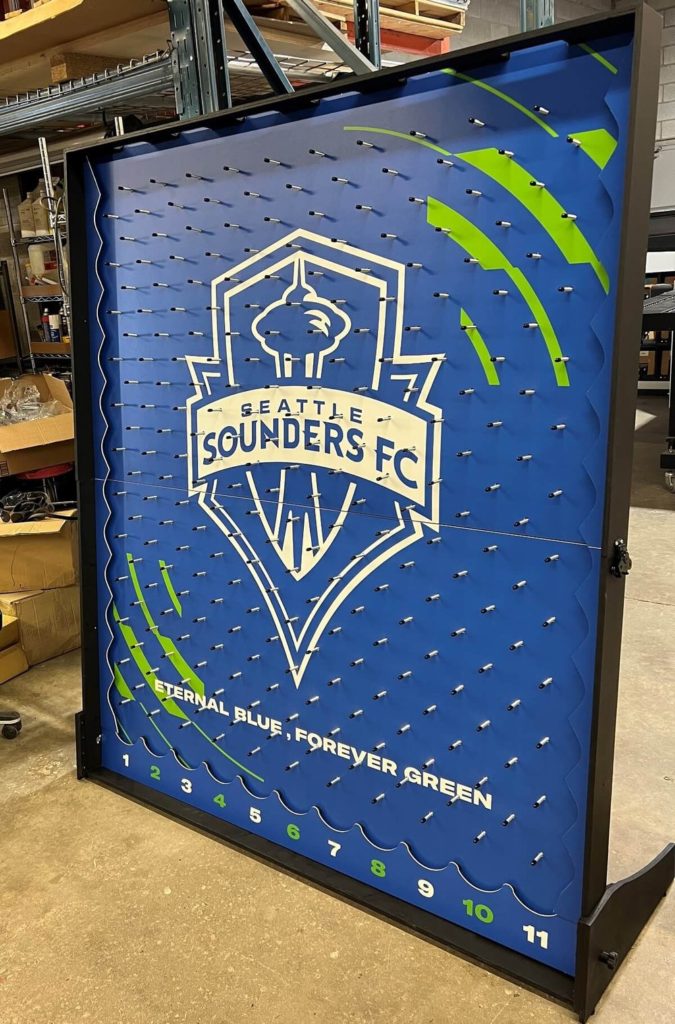 Custom branded Plinko board with Seattle Sounders FC logo, featuring pegs and prize slots.
