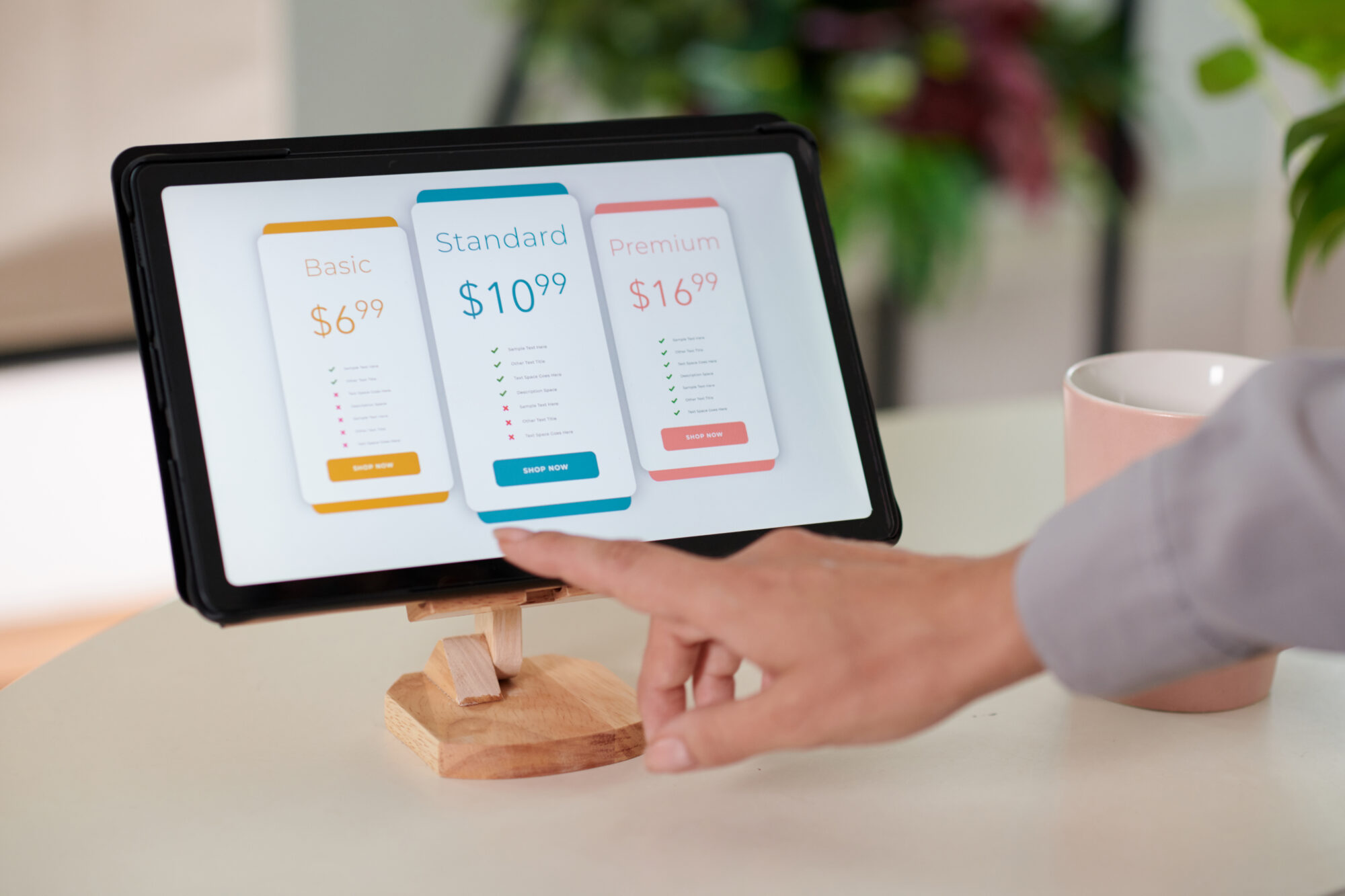 Customer selecting a pricing option on an interactive in-store kiosk with touch screen.
