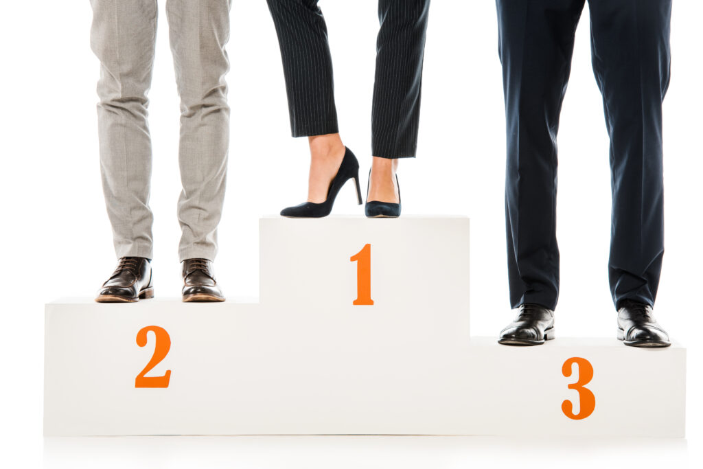 businesspeople standing on winners podium isolated on white