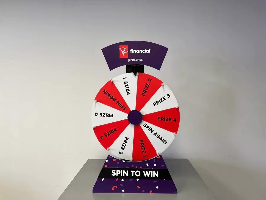 Custom branded spin to win prize wheel with red and white prize segments on a floor stand for events and retail